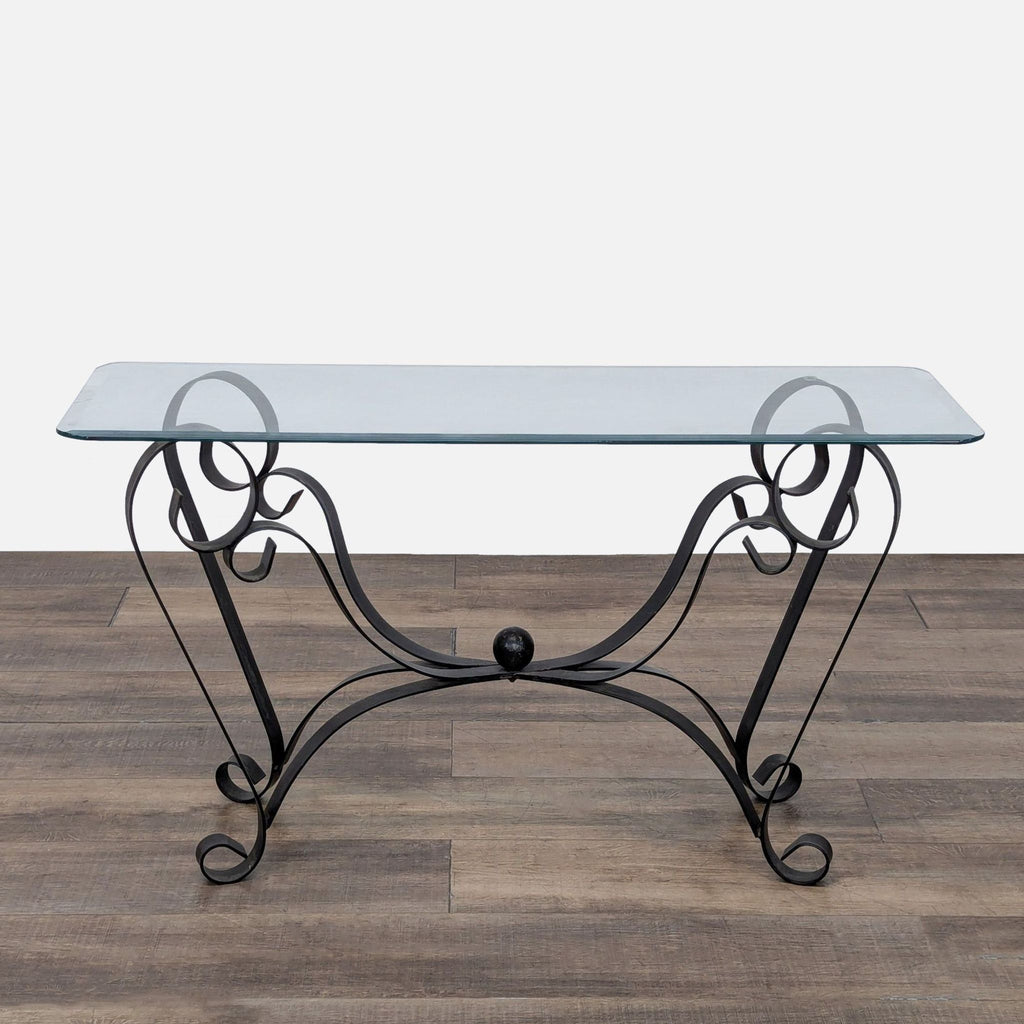 1. Reperch Side & Console Table with a glass top and decorative black wrought iron scrollwork legs, shown on wood floor.