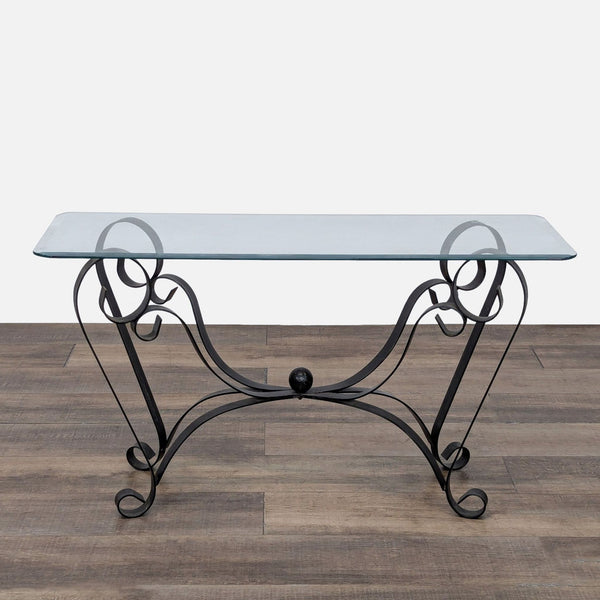 1. Reperch Side & Console Table with a glass top and decorative black wrought iron scrollwork legs, shown on wood floor.