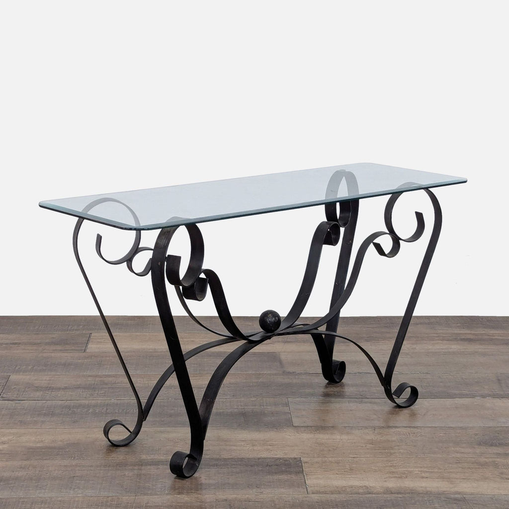 3. Angled view of the Reperch Side & Console Table featuring a clear glass surface and ornate metal scrollwork frame.