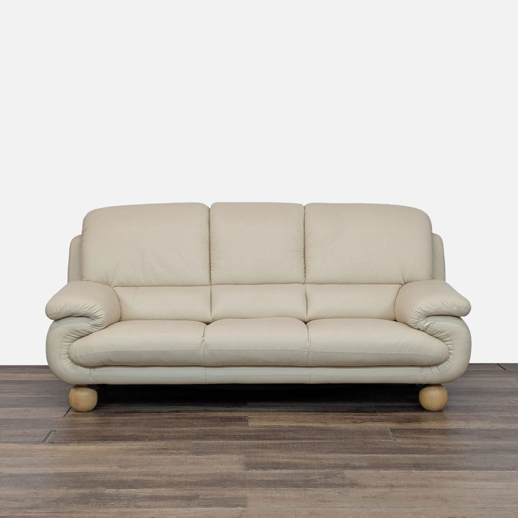 Cream Reperch 3-seat sofa with plush cushions, rounded arms, and wooden ball legs, front view.
