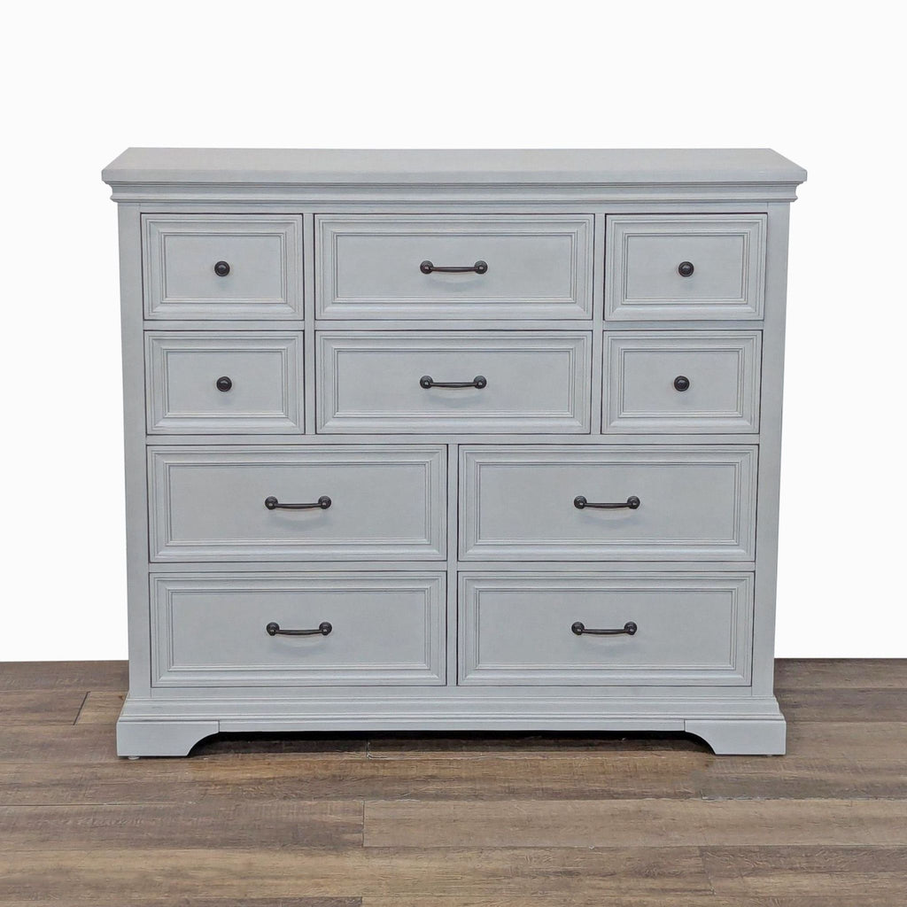 1. Front view of a Universal Broadmoore dresser with ten drawers, birch veneers, and bronze hardware.