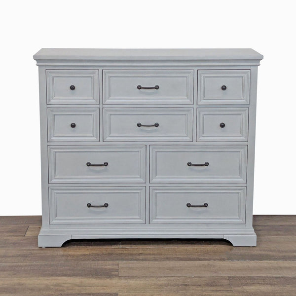 1. Front view of a Universal Broadmoore dresser with ten drawers, birch veneers, and bronze hardware.