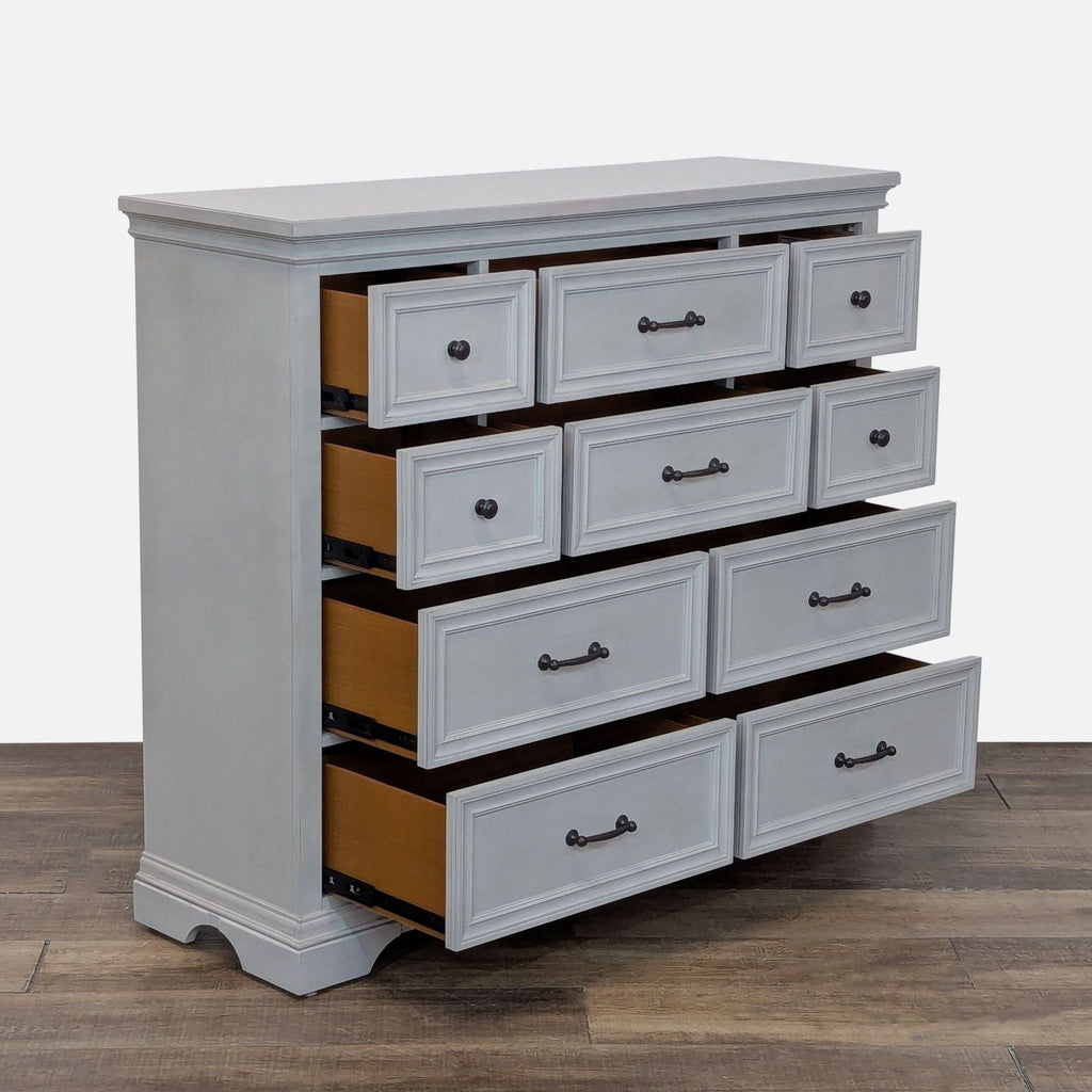 2. Angled view of a Universal Broadmoore dresser with all ten drawers open, showing dovetail construction.