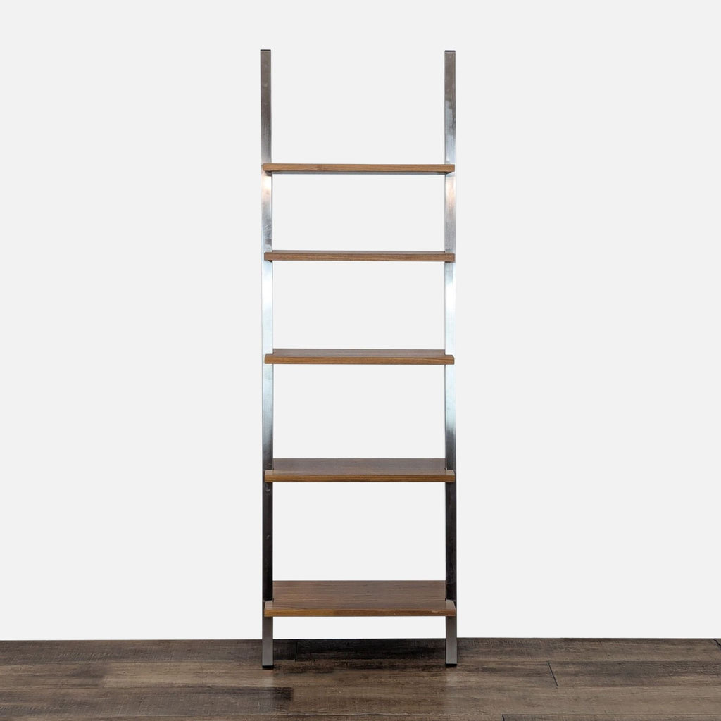 Room and Board bookshelf with a natural steel frame and maple wood shelves, shown on wood floor.