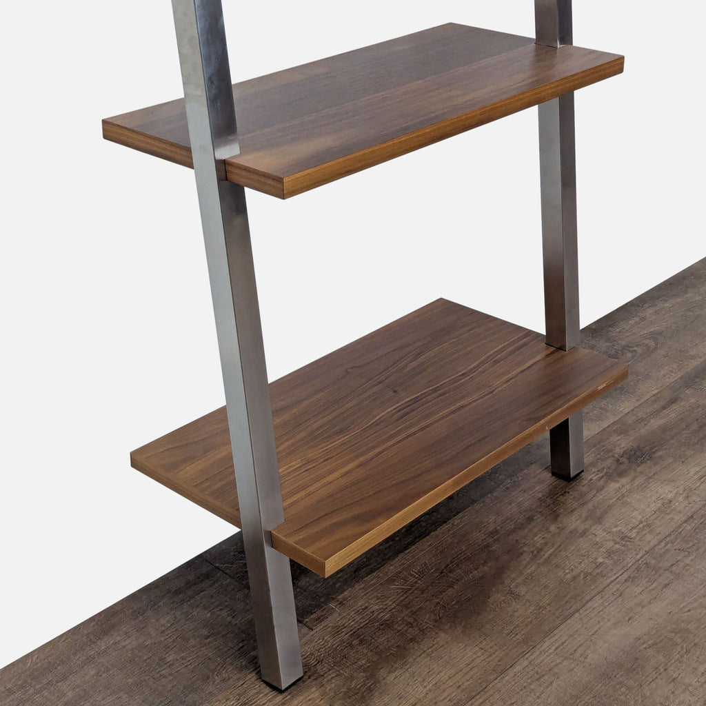 Close-up of maple wood shelves and steel frame on a Room and Board bookshelf, highlighting material details.