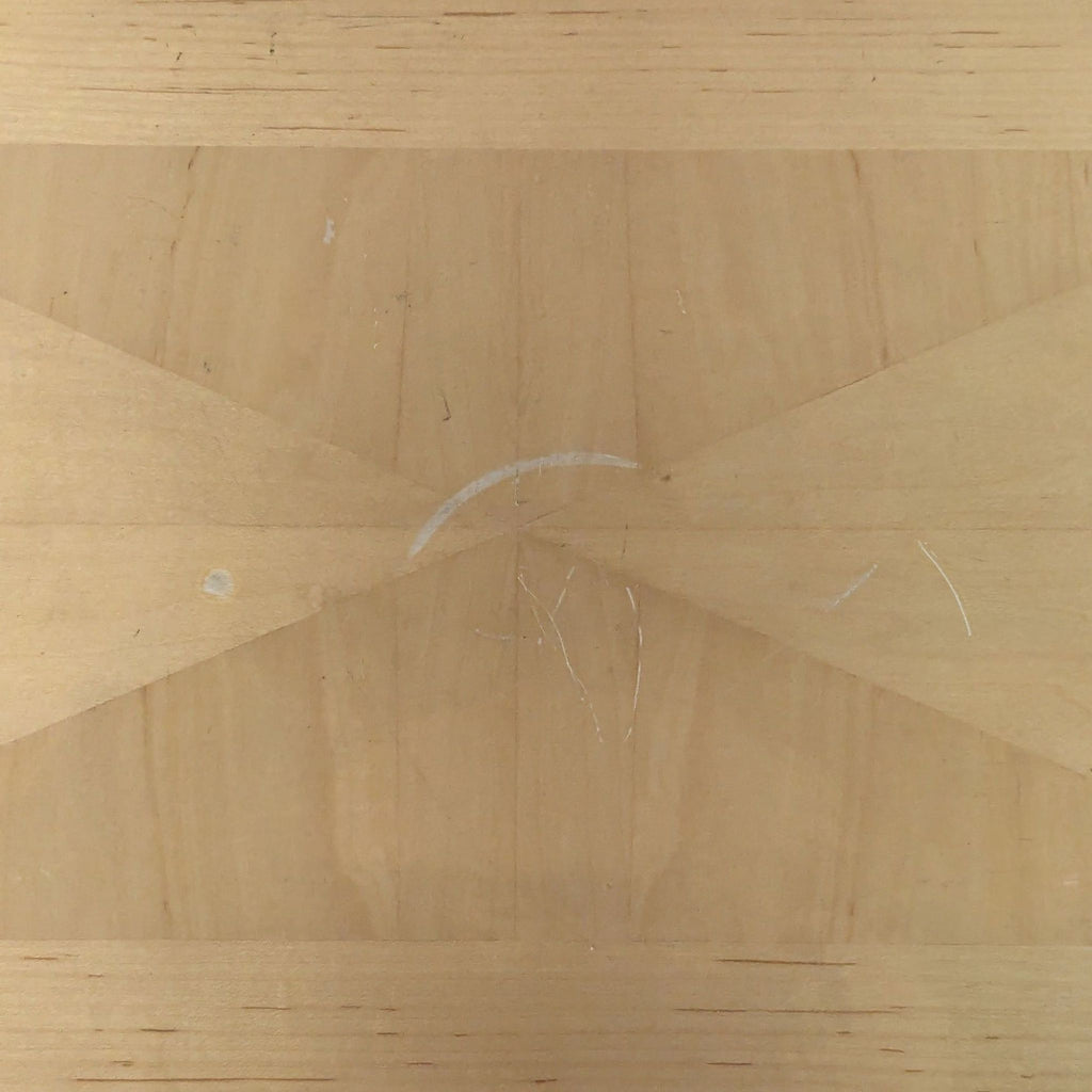 2. Close-up of tabletop showing geometric wood grain pattern and visible minor surface scratches.