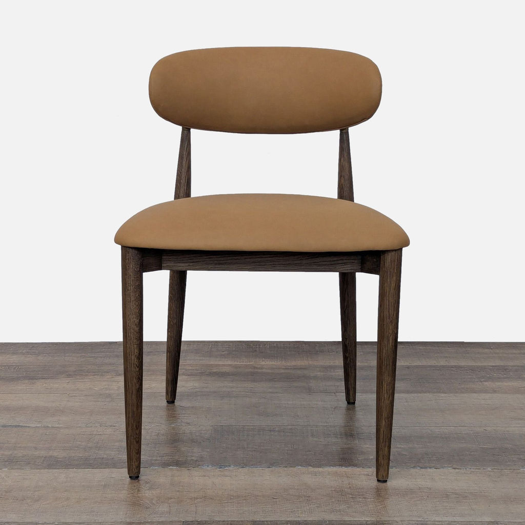 1. Front view of a Restoration Hardware dining chair with tan upholstery and dark wood legs.
