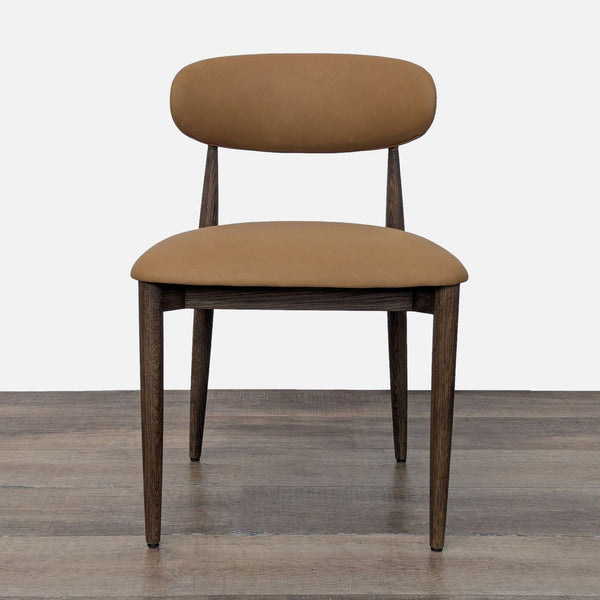 1. Front view of a Restoration Hardware dining chair with tan upholstery and dark wood legs.