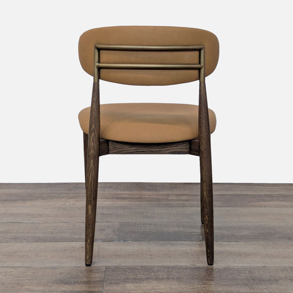 3. Rear view of a Restoration Hardware dining chair, featuring double metal bars on a tan upholstered backrest.