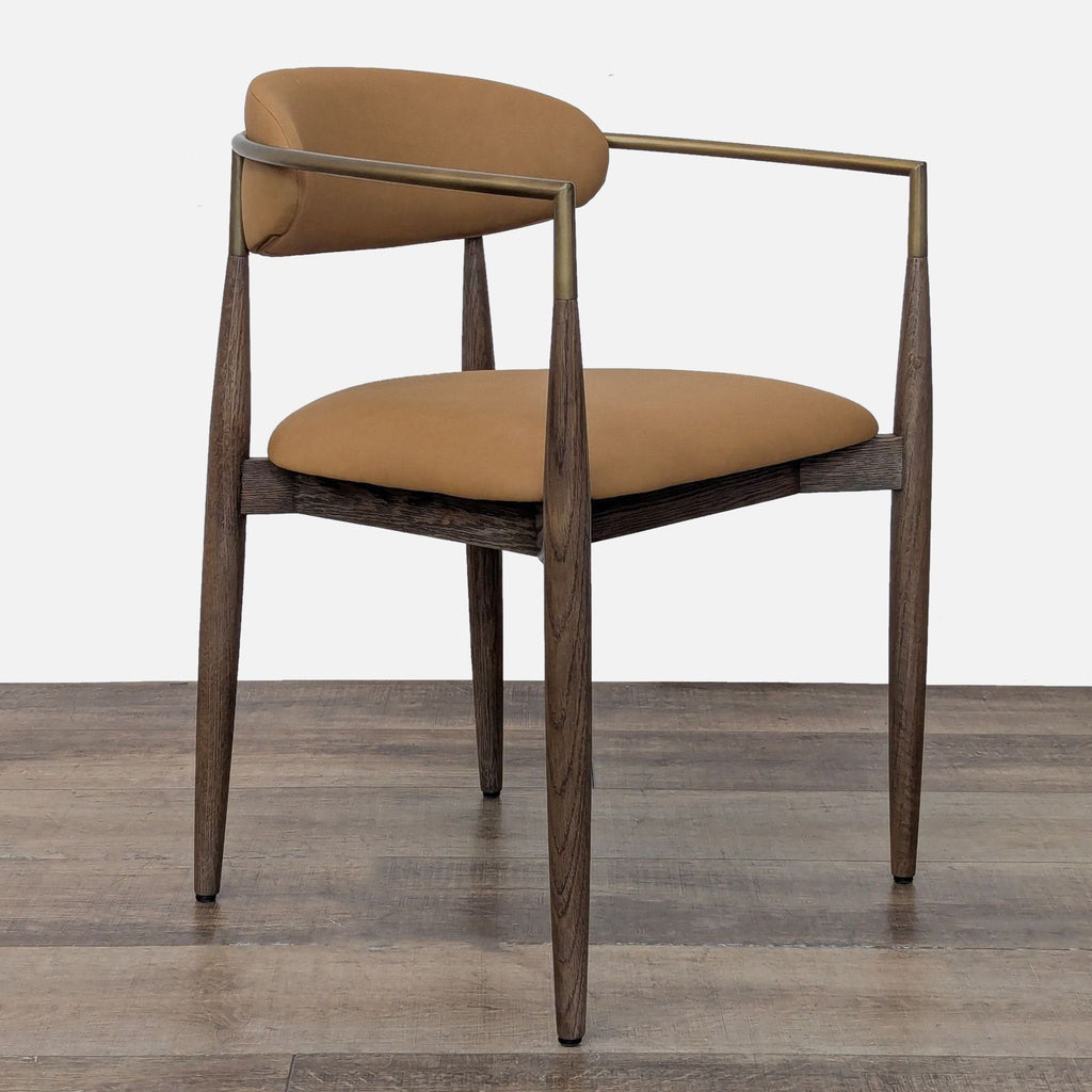2. Angled side view of a Restoration Hardware dining chair featuring a cushioned seat, bronze metal arms, and wooden legs.