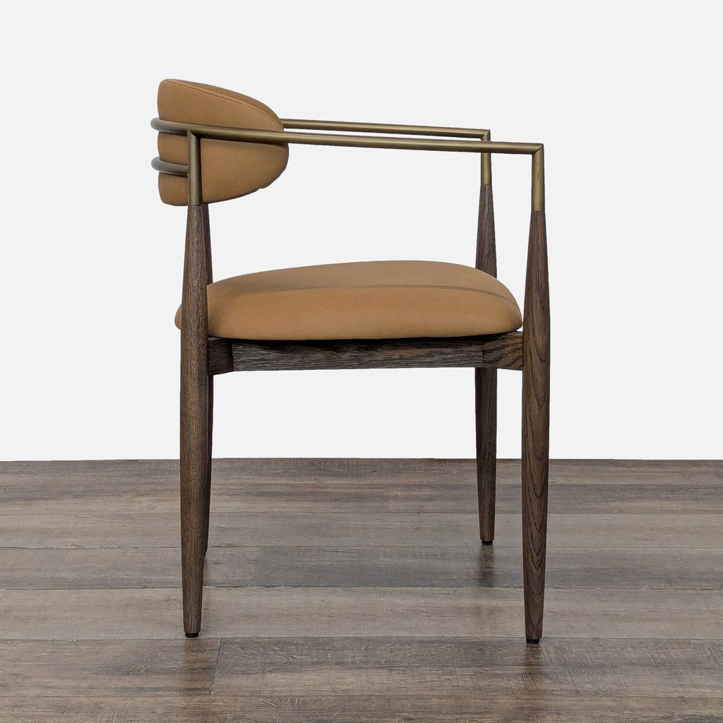 3. Profile view of a Restoration Hardware dining chair showing its tan upholstery, minimalist metal frame, and tapered wood legs.
