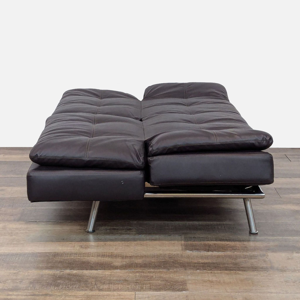2. Lifestyle Solutions 3-seat splitback sofa fully extended as a bed with pillow top and black leather upholstery.  