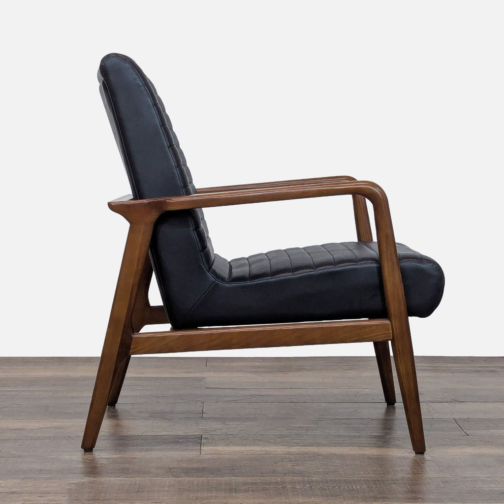 Side view of Reperch lounge chair showcasing wooden frame and black leather upholstery with channel tufting.  