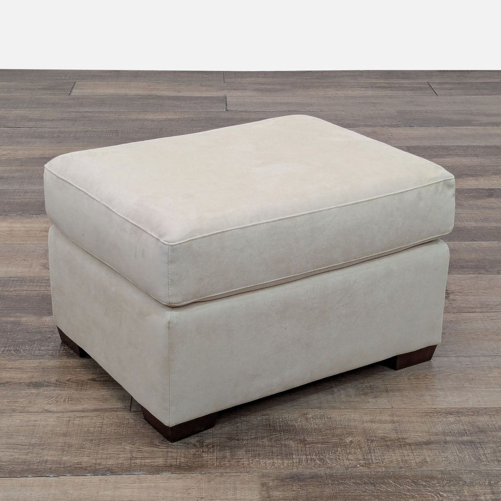 1. Rectangular beige ottoman from American Leather, Inc. on wooden legs, shown on a wood floor.