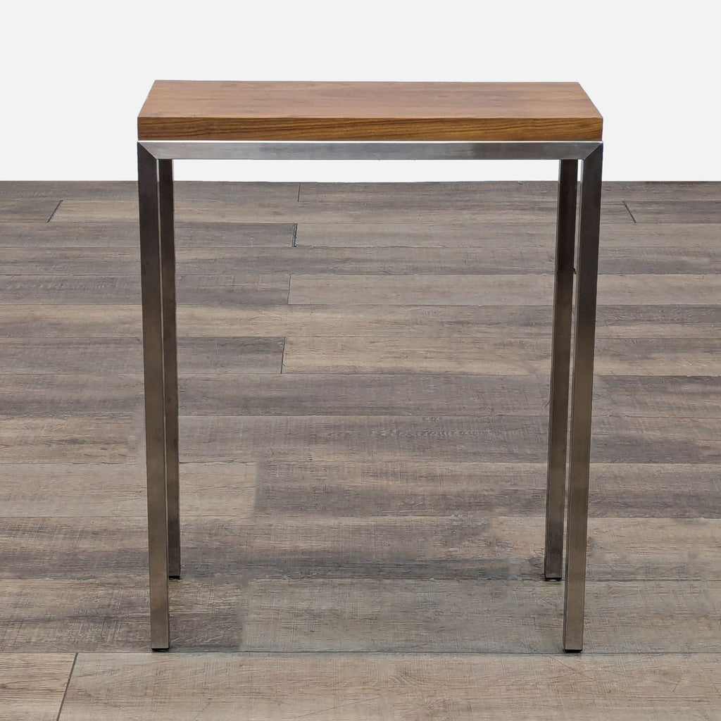 1. Room & Board side table with a rectangular wood top and metal legs, shown on a wood floor background.
