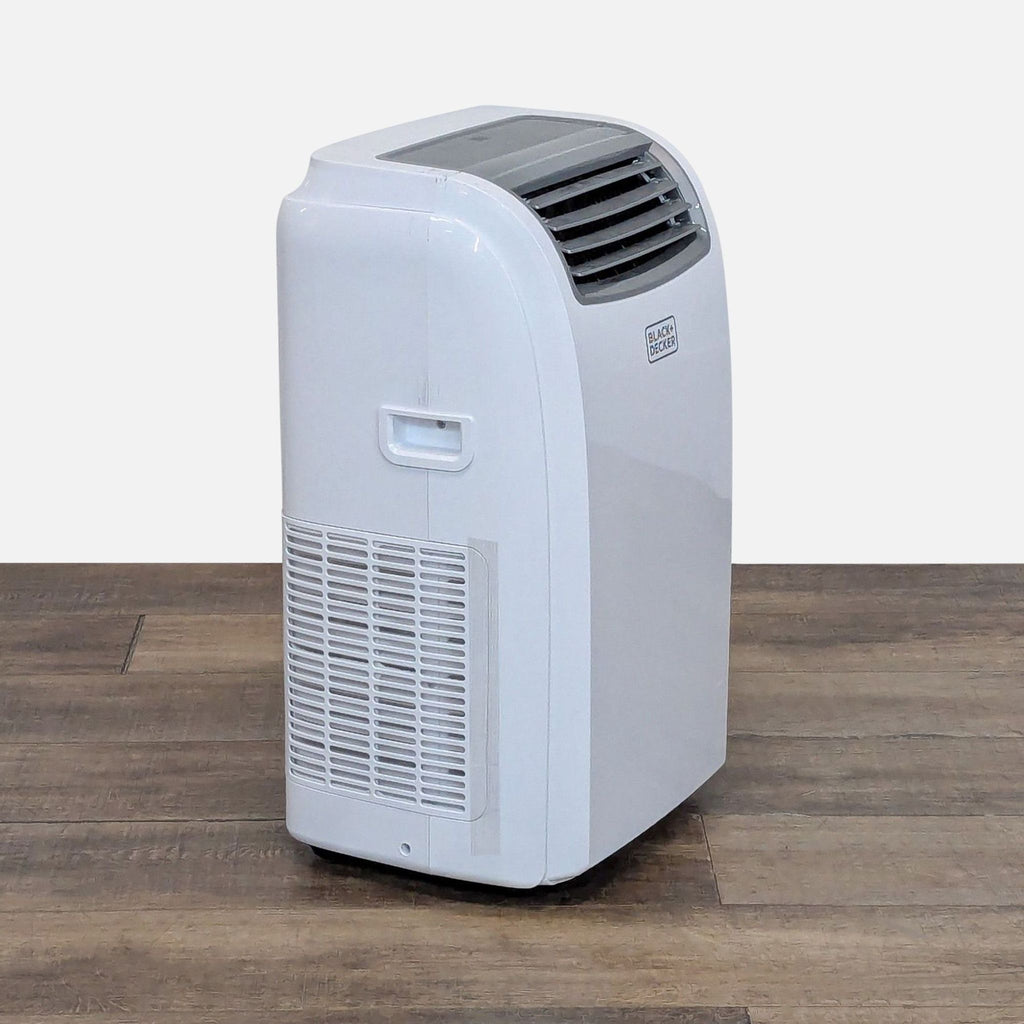 Side angle showing the handle and air vent of a Black & Decker portable air conditioner, designed for easy mobility.