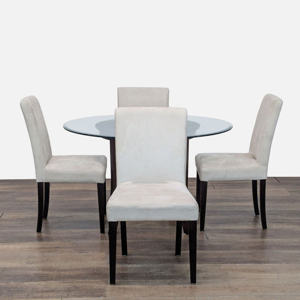 1. Crate & Barrel dining set with round glass table, wood base, and four cream upholstered Lowe chairs.