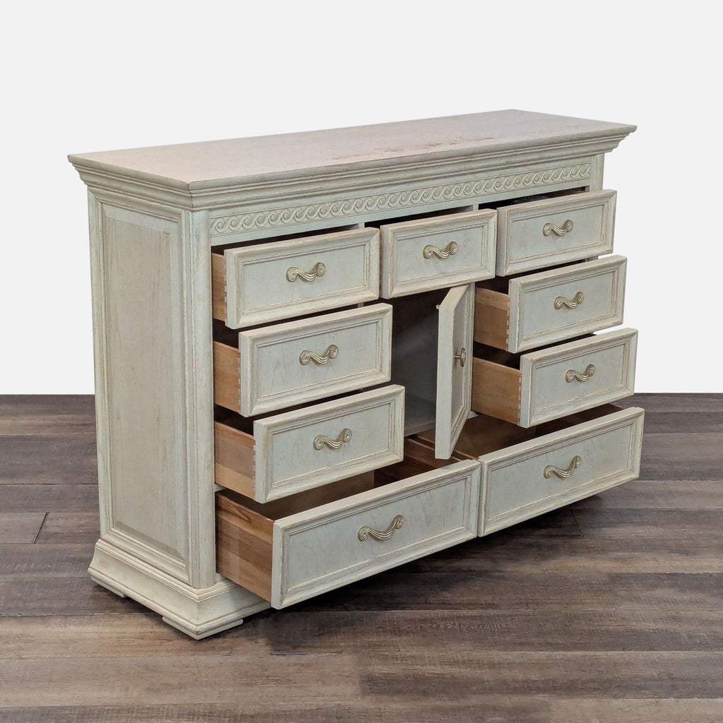 2. Angled view of Thomasville dresser, showing multiple open drawers and a central cabinet, white wash finish.