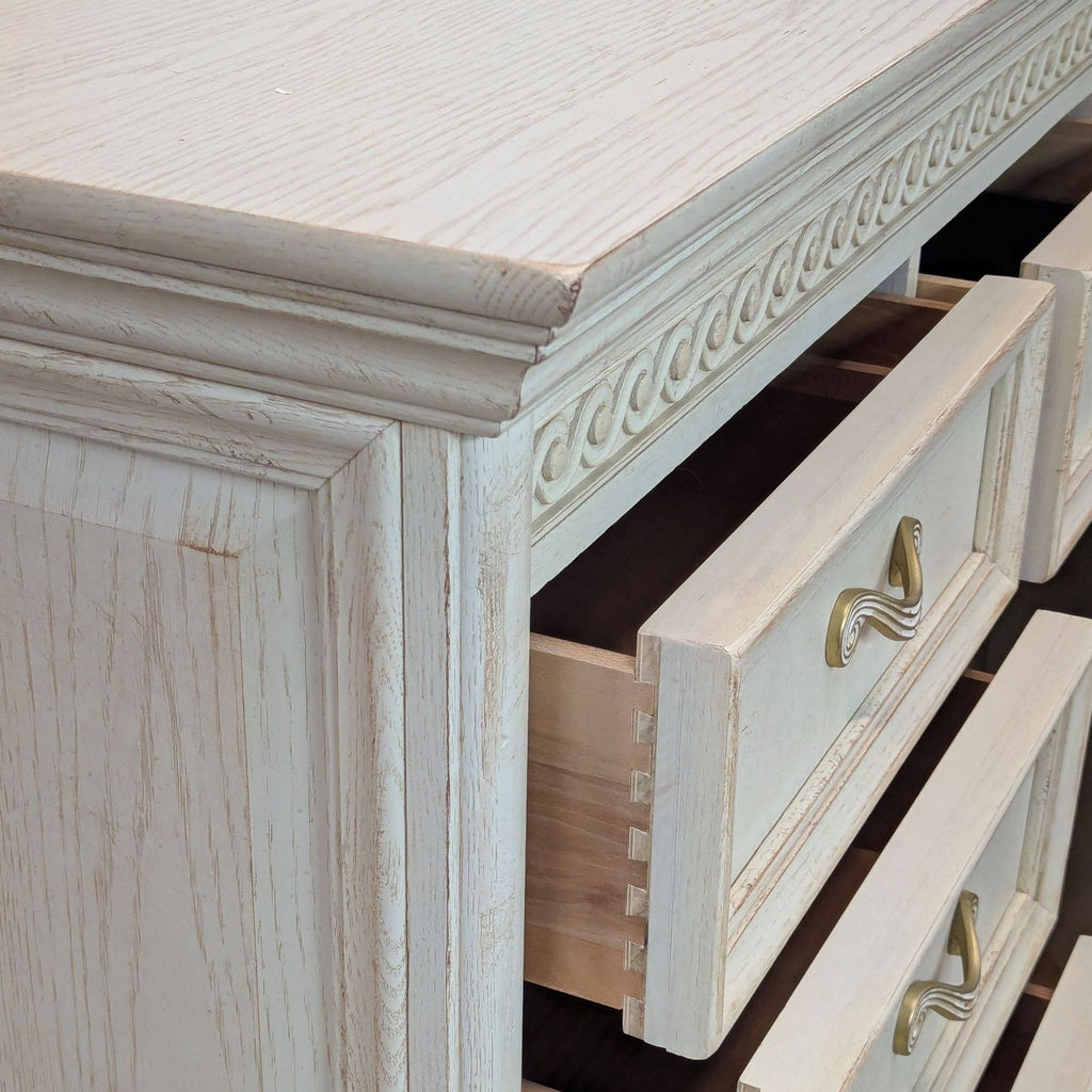 3. Close-up of dresser corner, highlighting white wash finish, dovetail joinery, and gold metal drawer pulls.