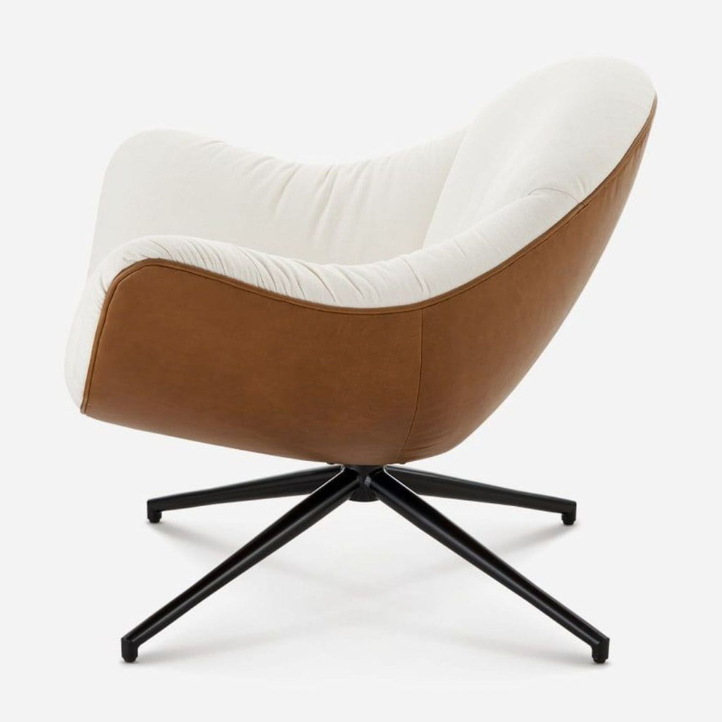 2. Side view of the Arden Swivel Armchair, tan upholstery back, cream seating, and black swivel legs.  