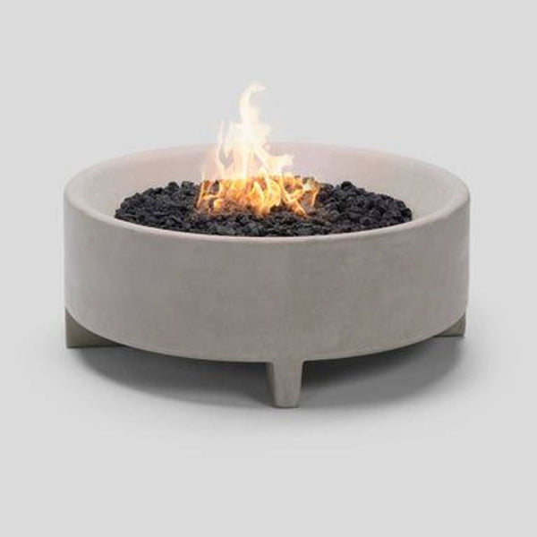 1. Modern round fire pit with sculptural concrete body, filled with lava rocks and a visible flame at center.  