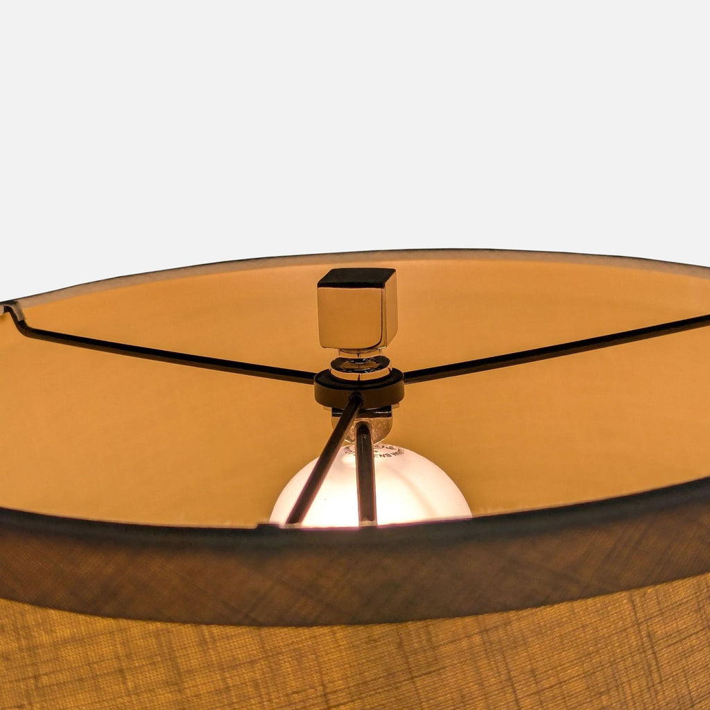 3. Interior view of drum linen shade on Restoration Hardware lamp, showing light bulb and metal supports.