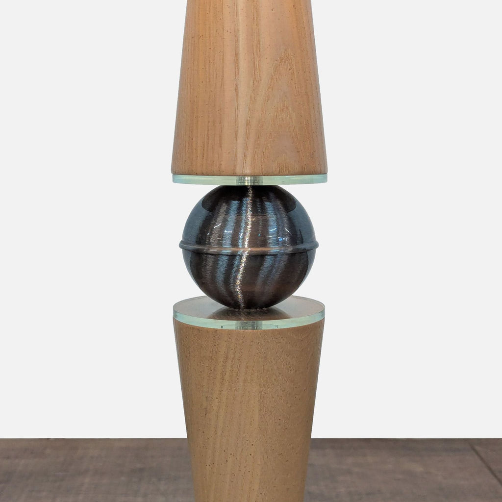 2. Close-up of lamp's wood base and metallic sphere detail, part of the Classic Brass Collection Lighting.