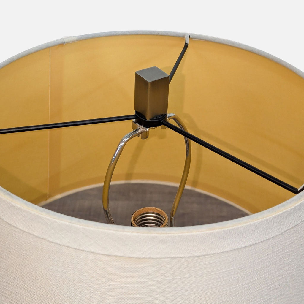 3. Interior view of the linen drum shade showing the metal harp and bulb socket of the Pottery Barn lamp.