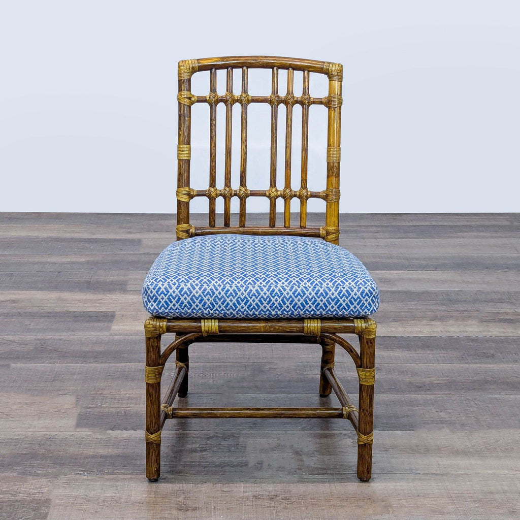 1. Front view of a McGuire dining chair by Elinor McGuire with woven rawhide and blue patterned cushion.
