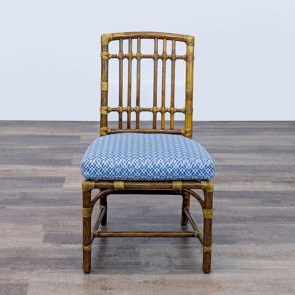 1. Front view of a McGuire dining chair by Elinor McGuire with woven rawhide and blue patterned cushion.