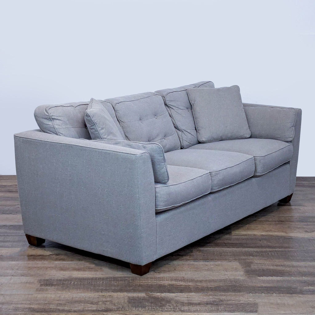 3. Angled view of La-Z-Boy 3-seat sofa highlighting its button-back, slim arms, and wood legs.