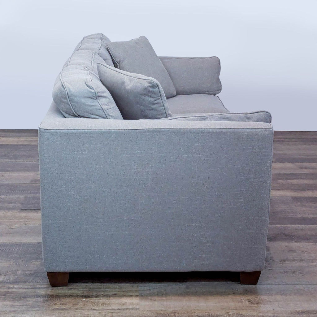 2. Side view of a modern La-Z-Boy 3-seater sofa showing slim arms and plush back cushions.  