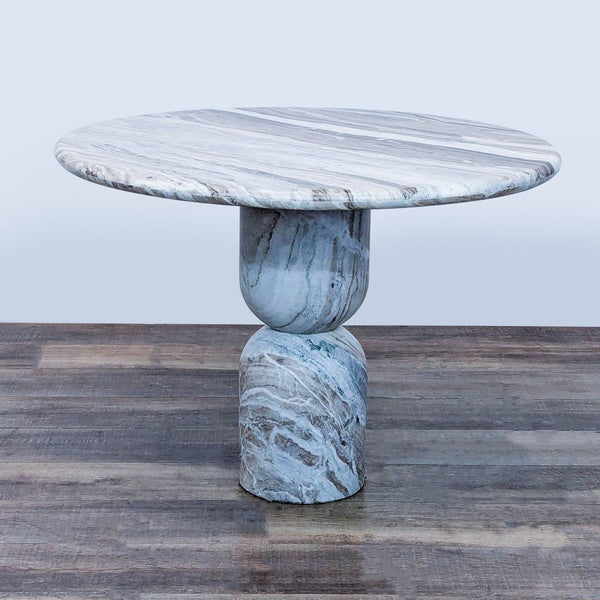 1. Round marble dining table with sculpted pedestal base and curved edges, designed by Amber Lewis for Amber Interiors.  
