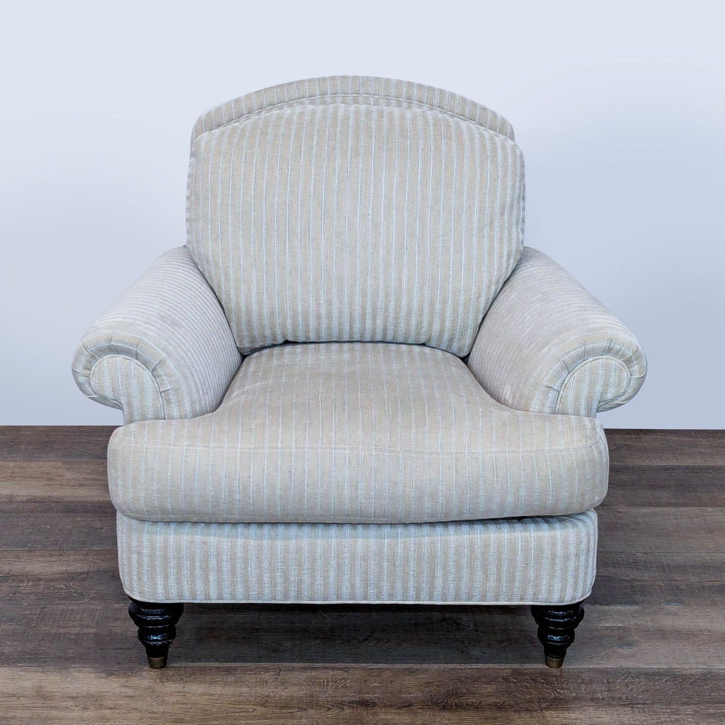 3. Reperch lounge seat with vertical striped fabric, rolled armrests, and dark wood legs with brass tips.