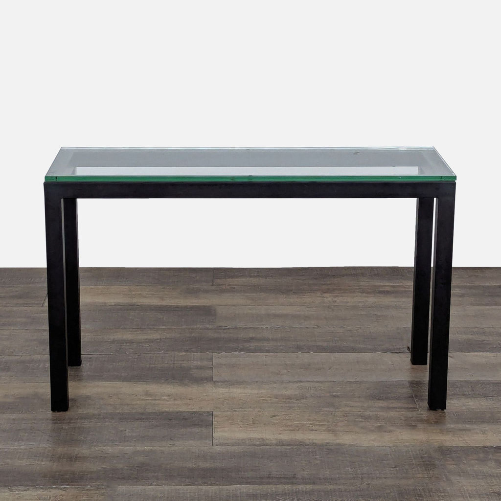 1. Crate and Barrel side console table with a clear glass top and powder-coated steel frame, modern design.