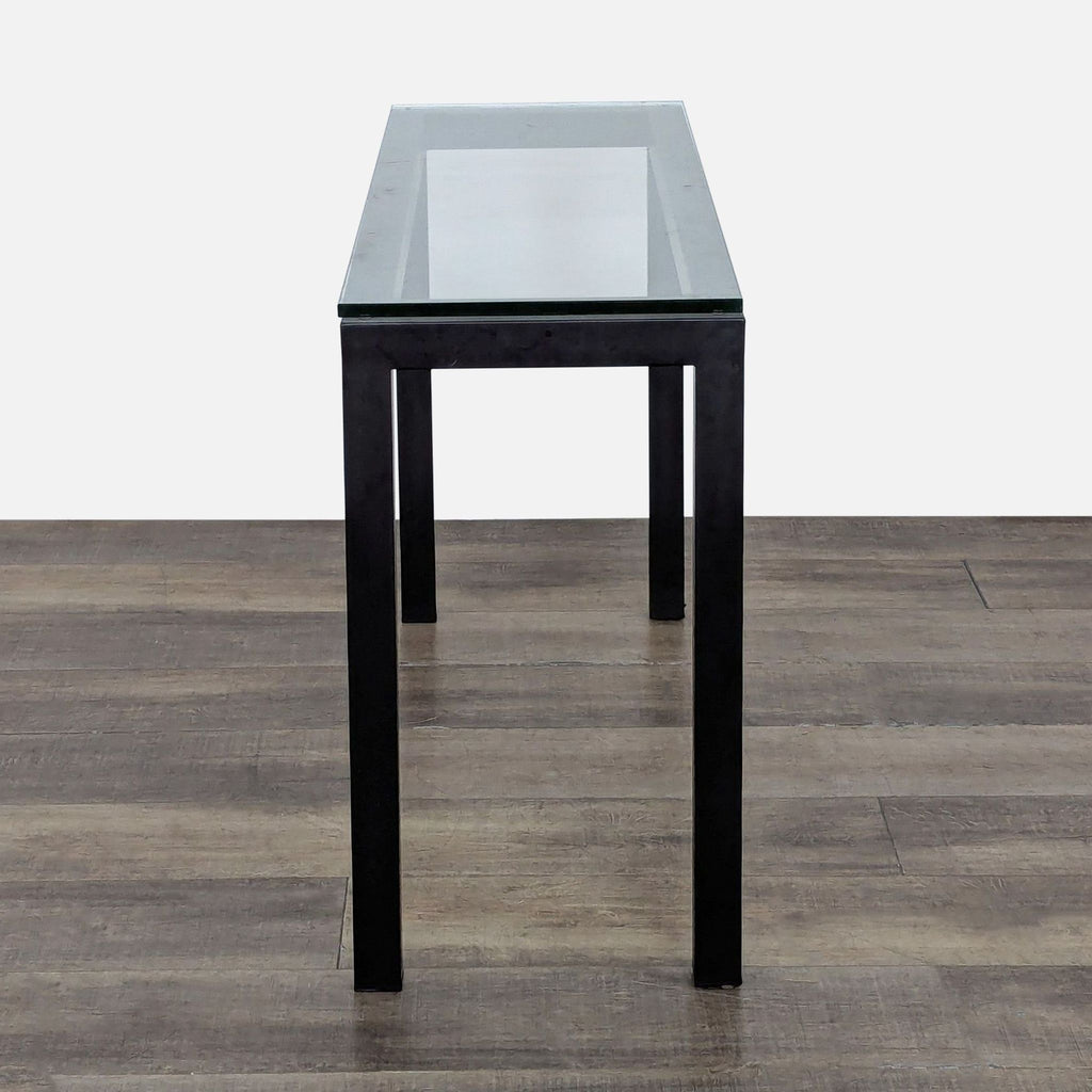 2. Sleek glass-top side table by Crate and Barrel, featuring a powder-coated steel base for stylish durability.