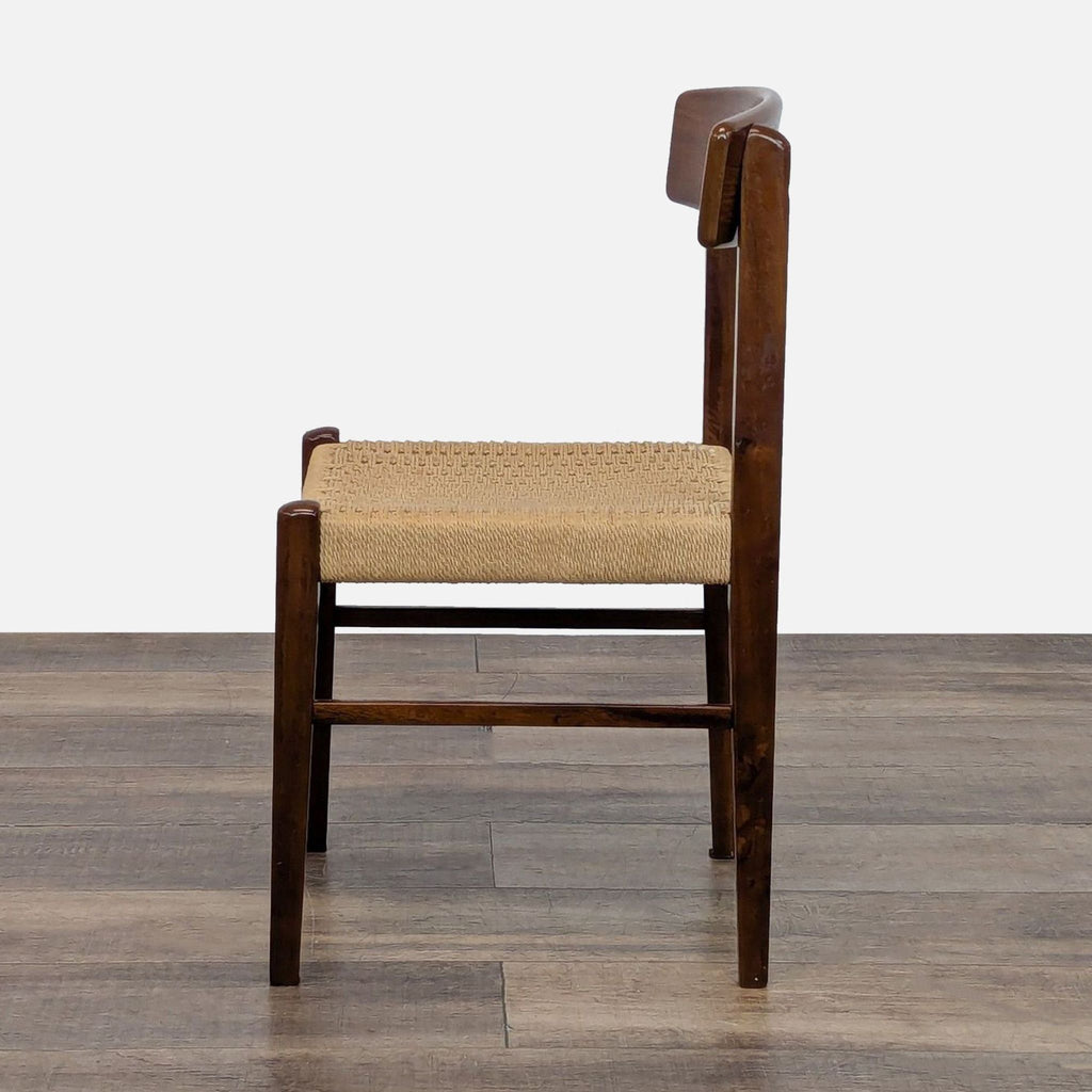 3. Side profile of a Reperch dining chair, displaying its sturdy wooden legs and textured, woven seat.