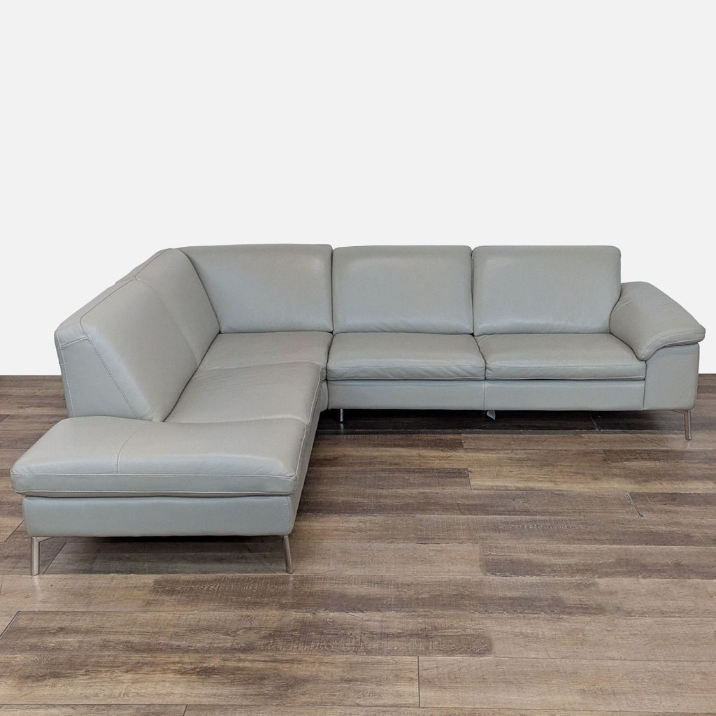 1. Nicoletti sectional with sleek lines, leather upholstery, and stainless steel legs on a wood floor.  