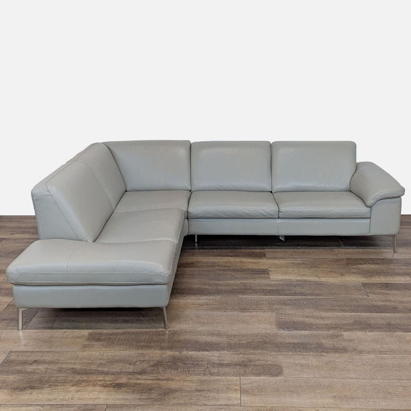 1. Nicoletti sectional with sleek lines, leather upholstery, and stainless steel legs on a wood floor.  