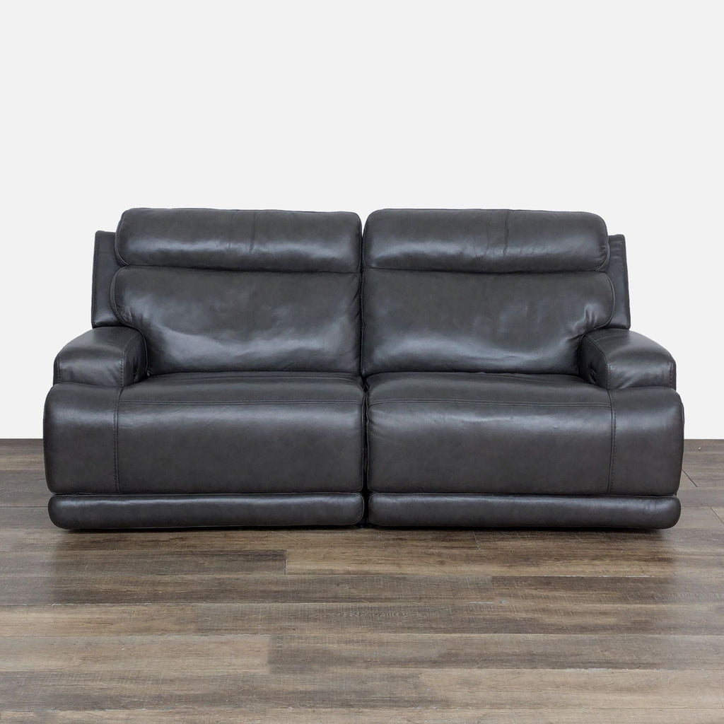 1. Living Spaces loveseat with power recline, adjustable headrests, and lumbar support, shown in dark leather.  