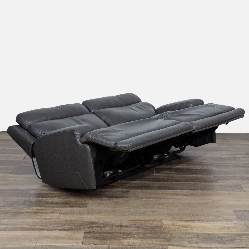 2. Reclined view of Living Spaces loveseat illustrating extended power recline and adjustable support features.  