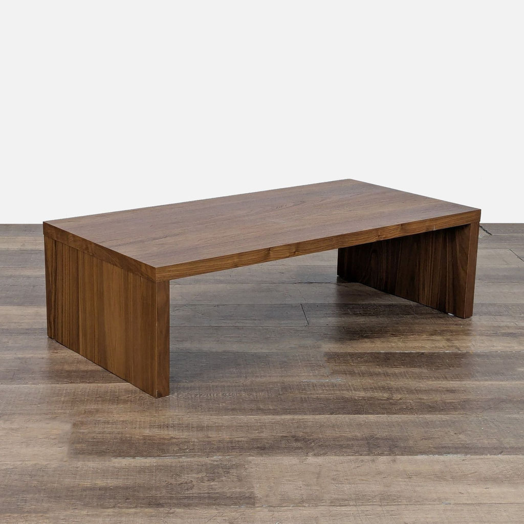 2. Angled view of a West Elm coffee table, showcasing its clean lines and rich wood grain.