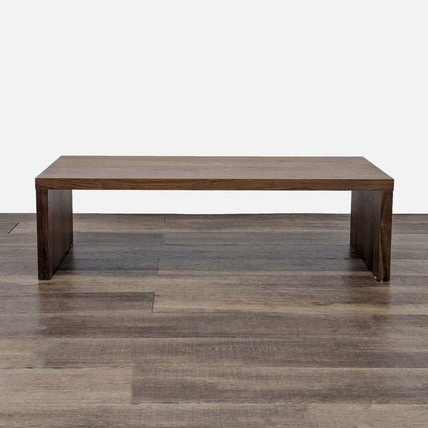 1. Rectangular wooden coffee table by West Elm with a minimal, modern design on wood flooring.