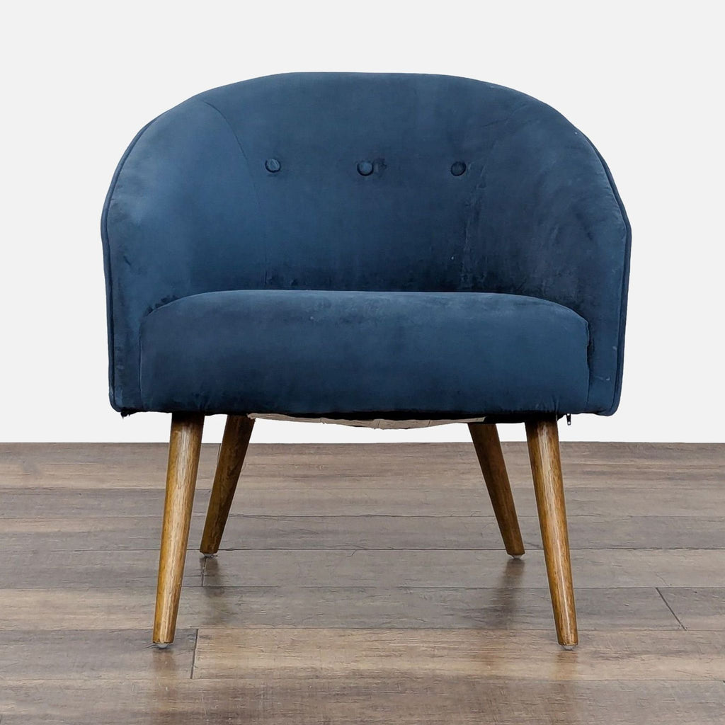 1. West Elm lounge chair with blue performance velvet, button tufting, and wooden legs, front view.