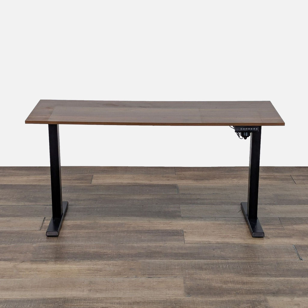 Front view of a Reperch adjustable standing desk with wood grain laminate top and black metal base.