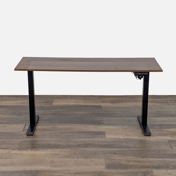 Front view of a Reperch adjustable standing desk with wood grain laminate top and black metal base.