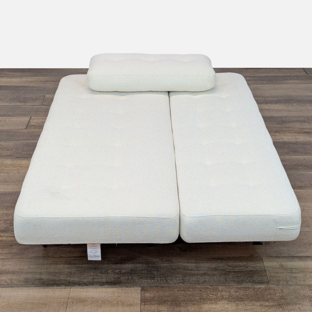 3. Room & Board sleeper sofa fully opened into bed position, showing storage sling underneath.