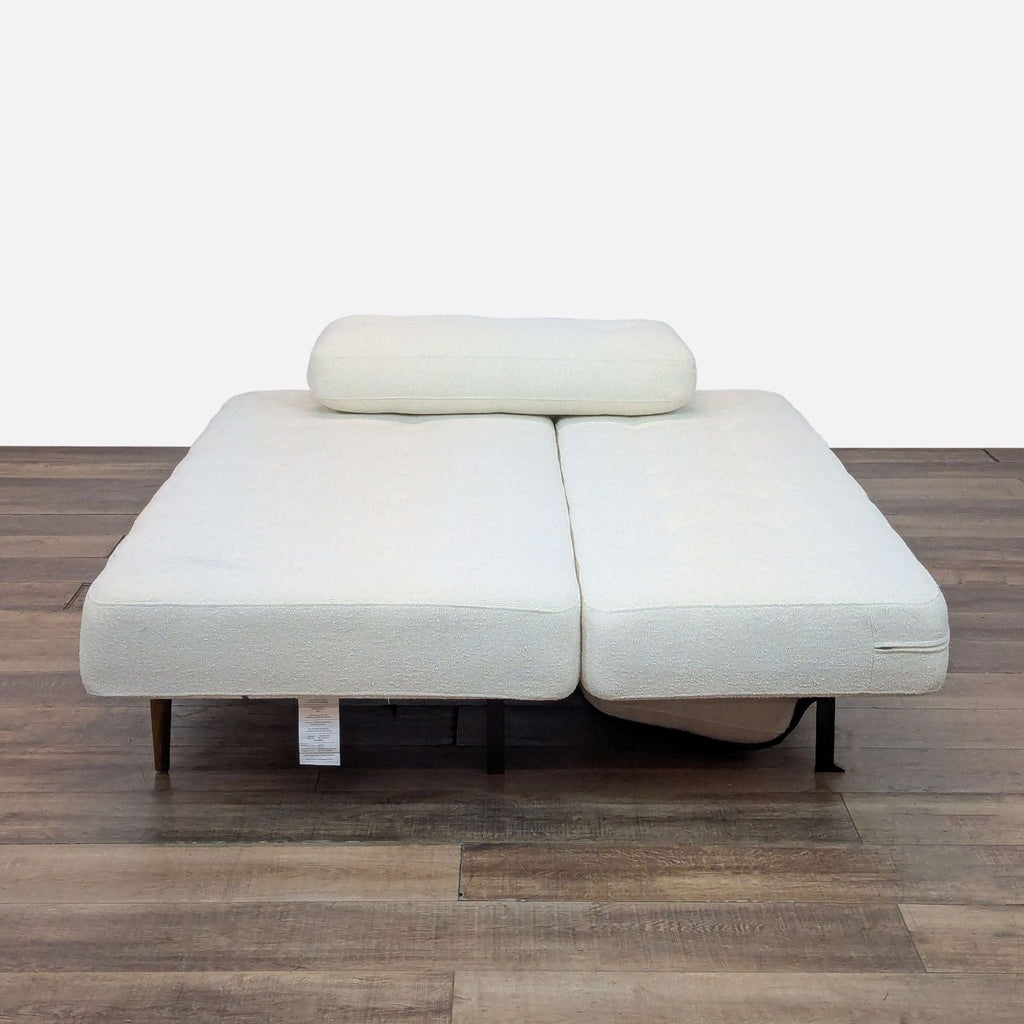 2. Sleeper sofa from Room & Board converted to bed with mattress and headrest cushion visible.