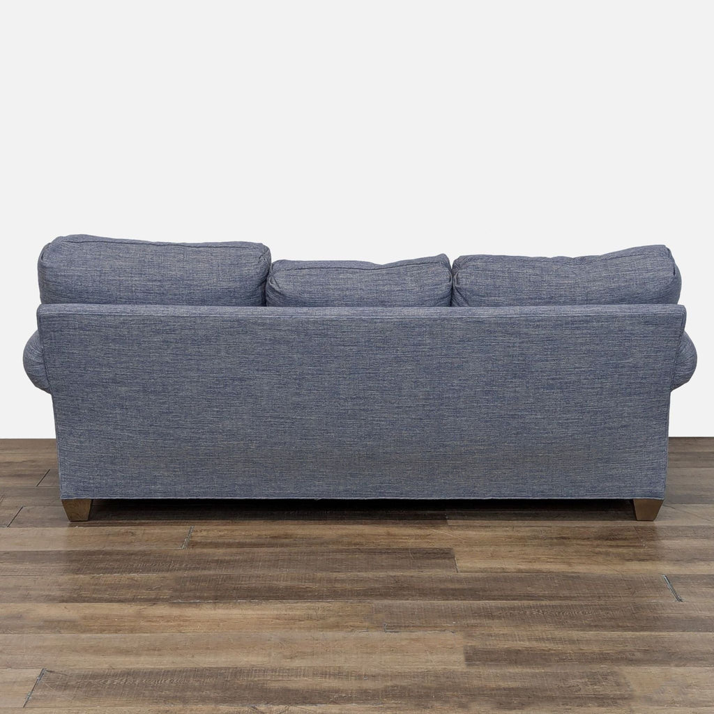 Rear view of a Reperch 3-seat sofa featuring heathered blue upholstery and wood legs.