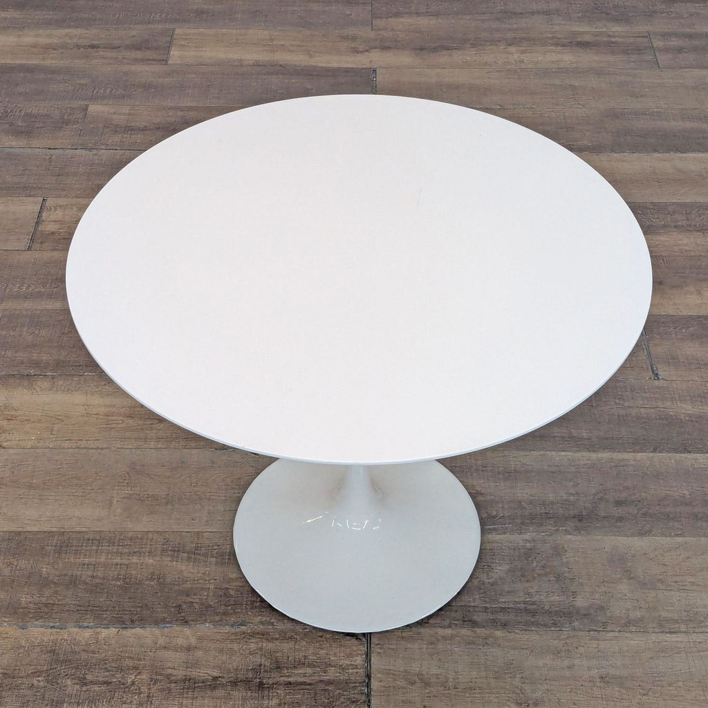 Top-down view of a Reperch modern round dining table in white, highlighting its smooth surface and shape.
